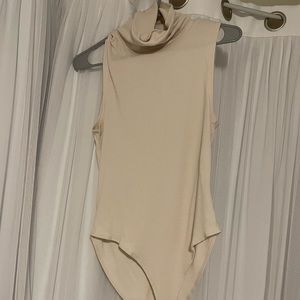 Turtleneck sleeveless bodysuit with button closure